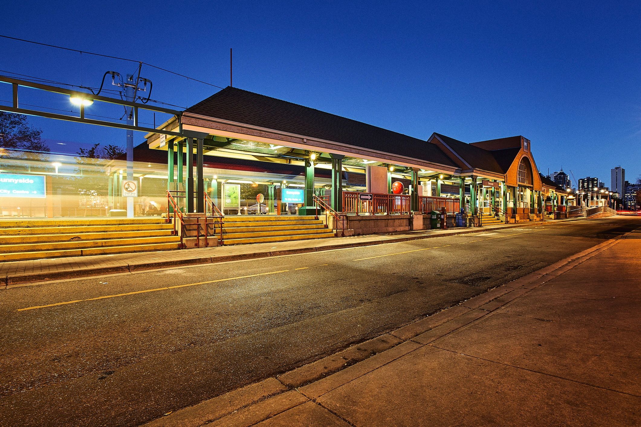 Illuminated transit station signage at night