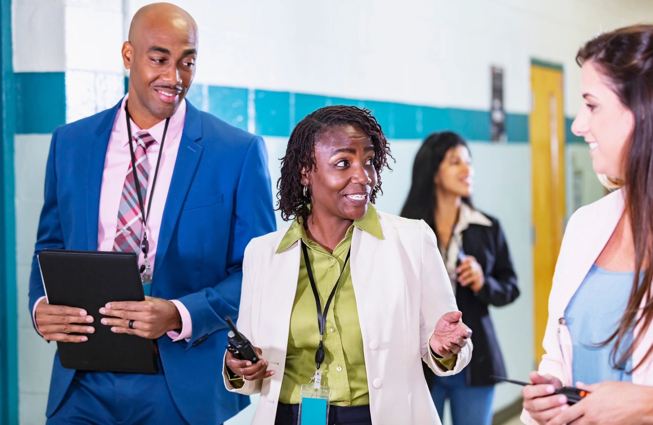 Professionals walking and talking together in a business hallway